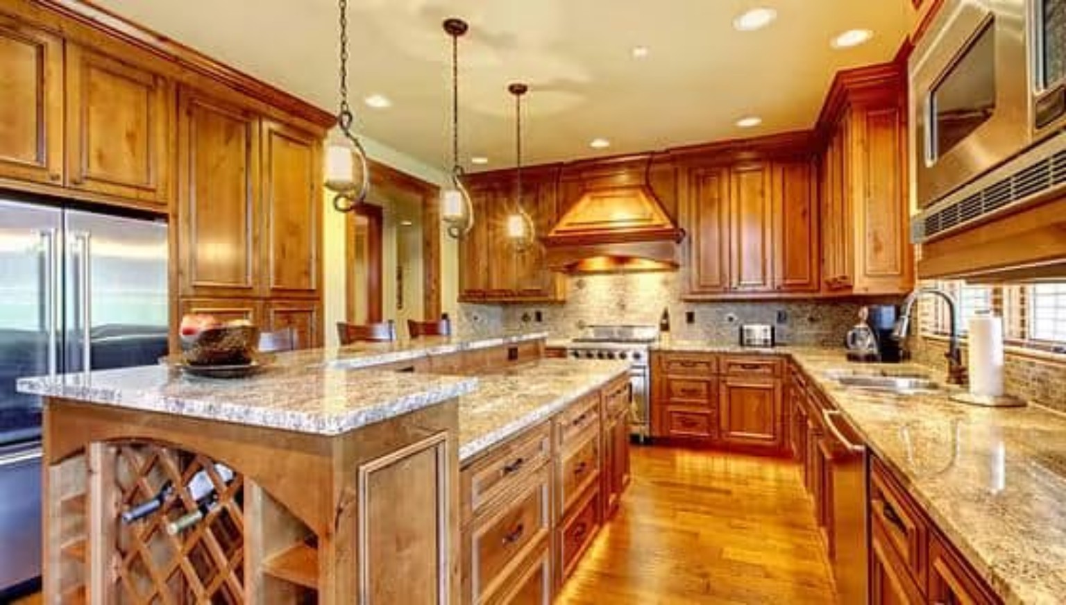 Custom kitchen with rich wood cabinetry, granite counters, and detailed millwork